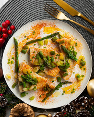 Grilled swordfish with green asparagus. Top view table with Christmas decorations.