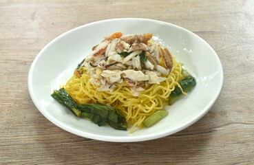Chinese egg yellow noodles topping crab meat on plate