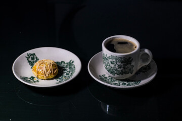 a cup of coffee with a cookies