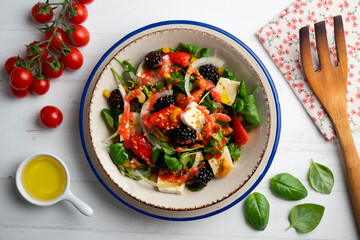 Healthy red berry and brie salad. Top view table with  decorations.
