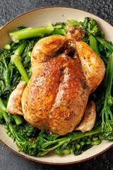 Roasted whole chicken with tenderstem broccoli peas and beans. Low carb food concept