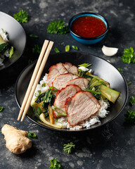 Chinese BBQ Pork Char Siu with rice and bok choy in a black bowl