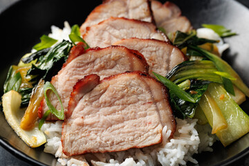 Chinese BBQ Pork Char Siu with rice and bok choy in a black bowl