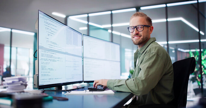 Computer Programmer Writing Program Code On Computer