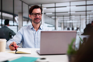 Man Studying Online On Laptop With Headphones