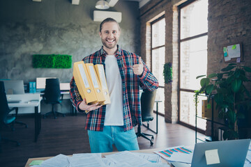 Photo of young corporate man hold folders show thumb up wear shirt loft interior modern office...