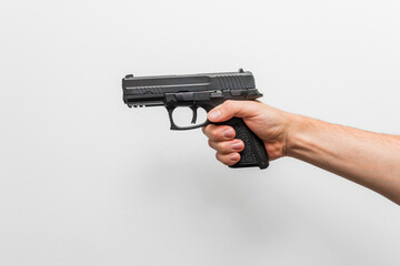 A person holding a handgun, focusing on firearm safety or a self-defense theme.