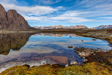 Clear lake reflecting the mountains of the Bjorne Islands, or Bear Islands, situated in Scorseby...