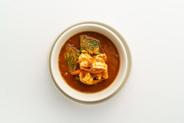 Delicious shrimp curry in a white bowl