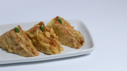 Roti Goreng is common fritter snack in Indonesia which made of white bread filled with creamy chicken and vegetable.