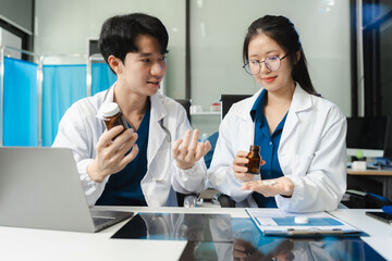 Fototapeta premium Pharmacists or doctors study information about drug analyzed results of medical reports.