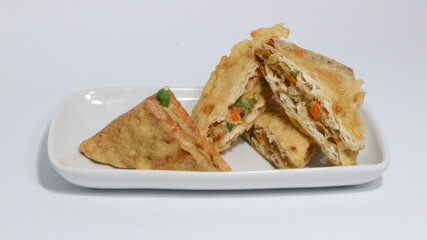 Roti Goreng is common fritter snack in Indonesia which made of white bread filled with creamy chicken and vegetable.