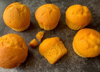Orange muffins on a black background. Flatlay photo of homemade muffins