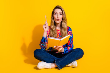 Full body photo of attractive young woman eureka write notebook dressed stylish colorful clothes isolated on yellow color background