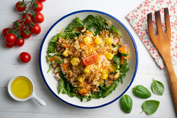 Healthy rice, pineapple and turkey salad. Top view table with  decorations.