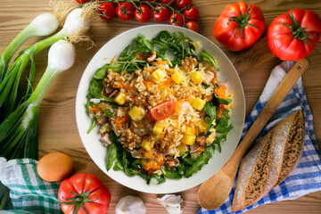 Healthy rice, pineapple and turkey salad. Top view table with  decorations.