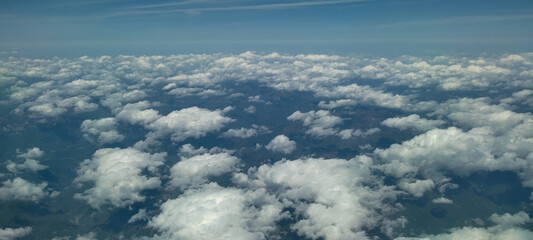 Puffy clouds with blue sky for background view from airplane