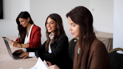 Three successful businesswomen attending a business conference