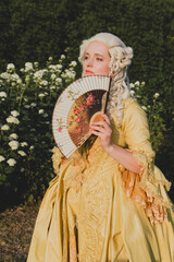 Fototapeta premium Portrait of blonde woman dressed in historical Baroque clothes with old fashion hairstyle