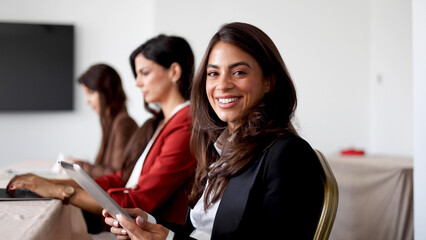 Beautiful businesswoman and her female business partners on a business conference
