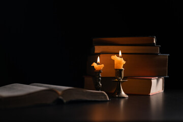 Dark, an antique candle cast its light on the old Bible, its flames flickering gently over the book...