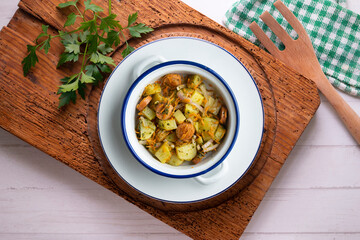 Healthy potato, onion and sausage salad. Top view table with decorations.