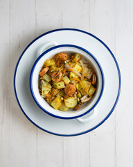 Healthy potato, onion and sausage salad. Top view table with decorations.