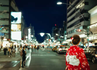 Asian girl standing out from the crowd at a city street in Japan.