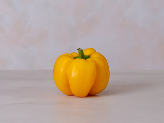 one yellow pepper, light background, photo straight on, vegan diet ingredient