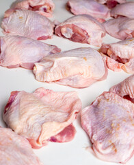 Chicken pieces on a white table.