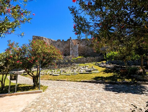 Remains of the walls, battlements, towers, stairs and fortifications of the old fortress of Patras, photographed on a sunny summer's day with a bright blue sky. Sightseeing and vacation in Greece.