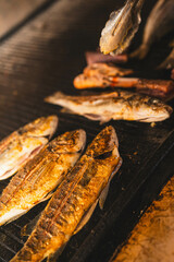 Grilled fish on a sizzling grill plate. Perfect for recipes, restaurants, or food bloggers looking to highlight fresh seafood or barbecue content.