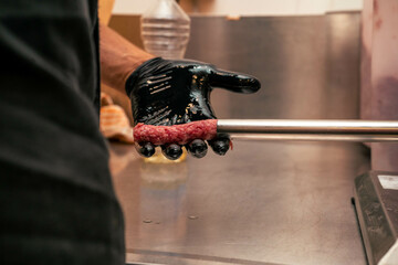 A dynamic shot of a chef's gloved hand shaping kebabs. Ideal for kebab-making tutorials or behind-the-scenes content, for chefs or businesses wanting to showcase authentic food prep.