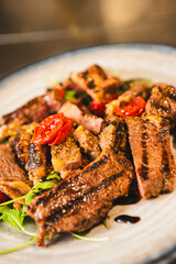A perfectly plated steak with cherry tomatoes and greens. Great for upscale menus, food bloggers, or anyone needing premium dish imagery for marketing or recipe posts.