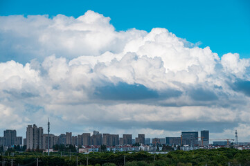 Fototapeta premium Cumulus clouds over the city in summer
