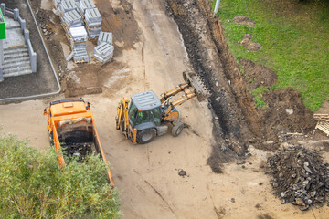 Aerial view of a construction site with dump truck and bulldozer