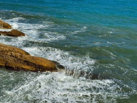 Stormy sea waves and coastal rocks.