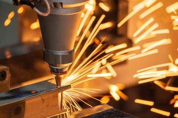Close up scene the fiber laser cutting machine cut the square shape stainless steel tube with...