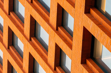 Close-up of the windows arranged in sequence on the orange building facade