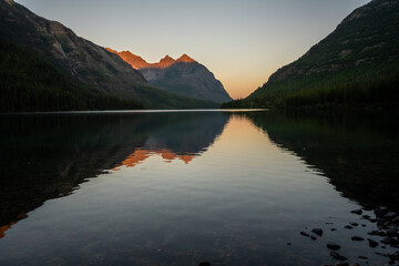 Orange Mountains Reflect In Upper Kintla Lake at Sunrise