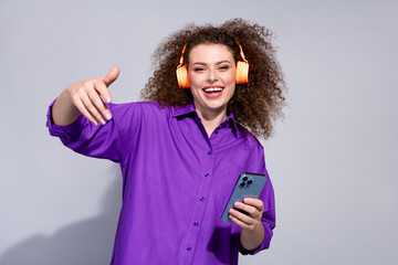 Photo of nice young woman phone headphones dance wear purple shirt isolated on grey color background