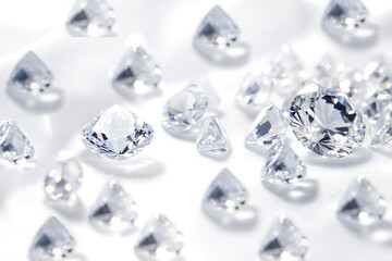Sparkling diamonds scattered on a white surface, reflecting light and showcasing their brilliance and clarity