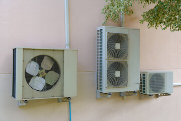 Air compressor or air condenser unit located on support outside building to heat released...