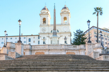 Beautiful landscape shot of the Spanish Steps (Piazza di Spagna) leading to the magnificent Trinità dei Monti church at the top, historical landmark and popular tourist destination in Rome, Italy