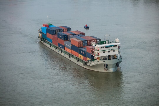 JIUJIANG,CHINA - June 15, 2024: Sunset cargo (container) ships travel along the Yangtze River. Ministry of Transport: China's cargo volume, port cargo throughput and personnel flow maintained steady 