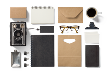 hipster style stationery or branding mockup with blank writing supplies, note pads, ring binder, paper clips, vintage analog camera, glasses and coffee isolated over transparency, flat lay / top view
