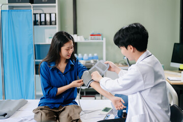 Asian male patient on bed while doctor hands of checking examining his pulse for record the treatment results