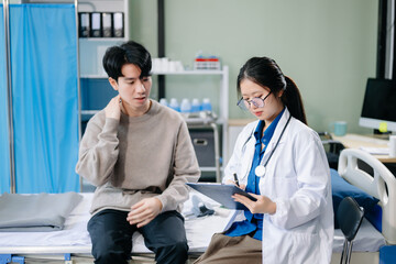 Obraz premium Asian male patient on bed while doctor hands of checking examining his pulse for record the treatment results