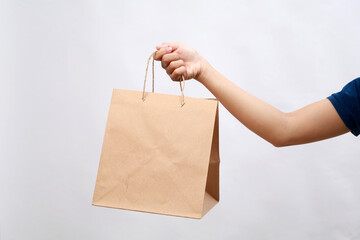 Diverse of paper containers for takeaway food. Woman holding take away paper bag over white...