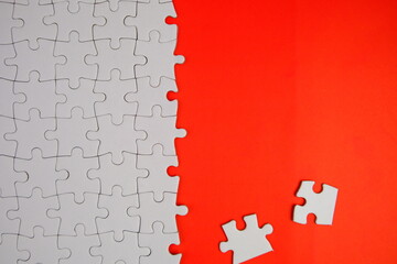 white jigsaw puzzle with missing puzzle for a text template. Above photo of isolated on the purple background